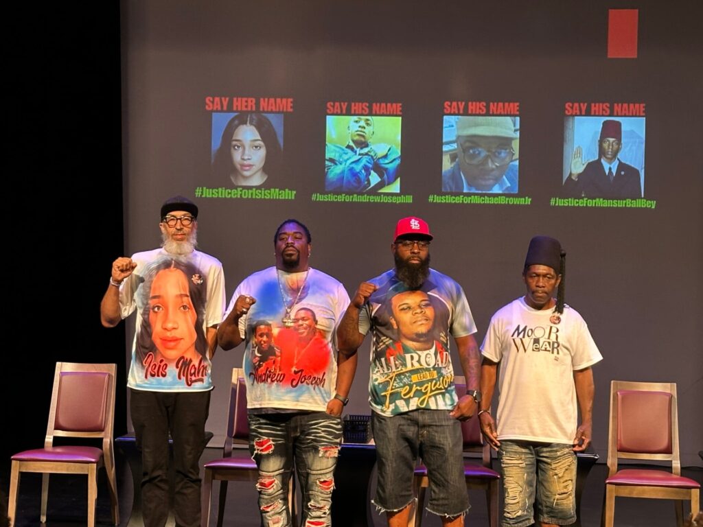 Four men standing in front of photos of their children lost to violence, including by the police