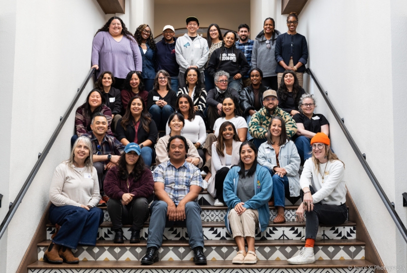 two dozen people who work at nonprofits supported by the Haas Fund's Endeavor Fund pose for a photo on a staircase